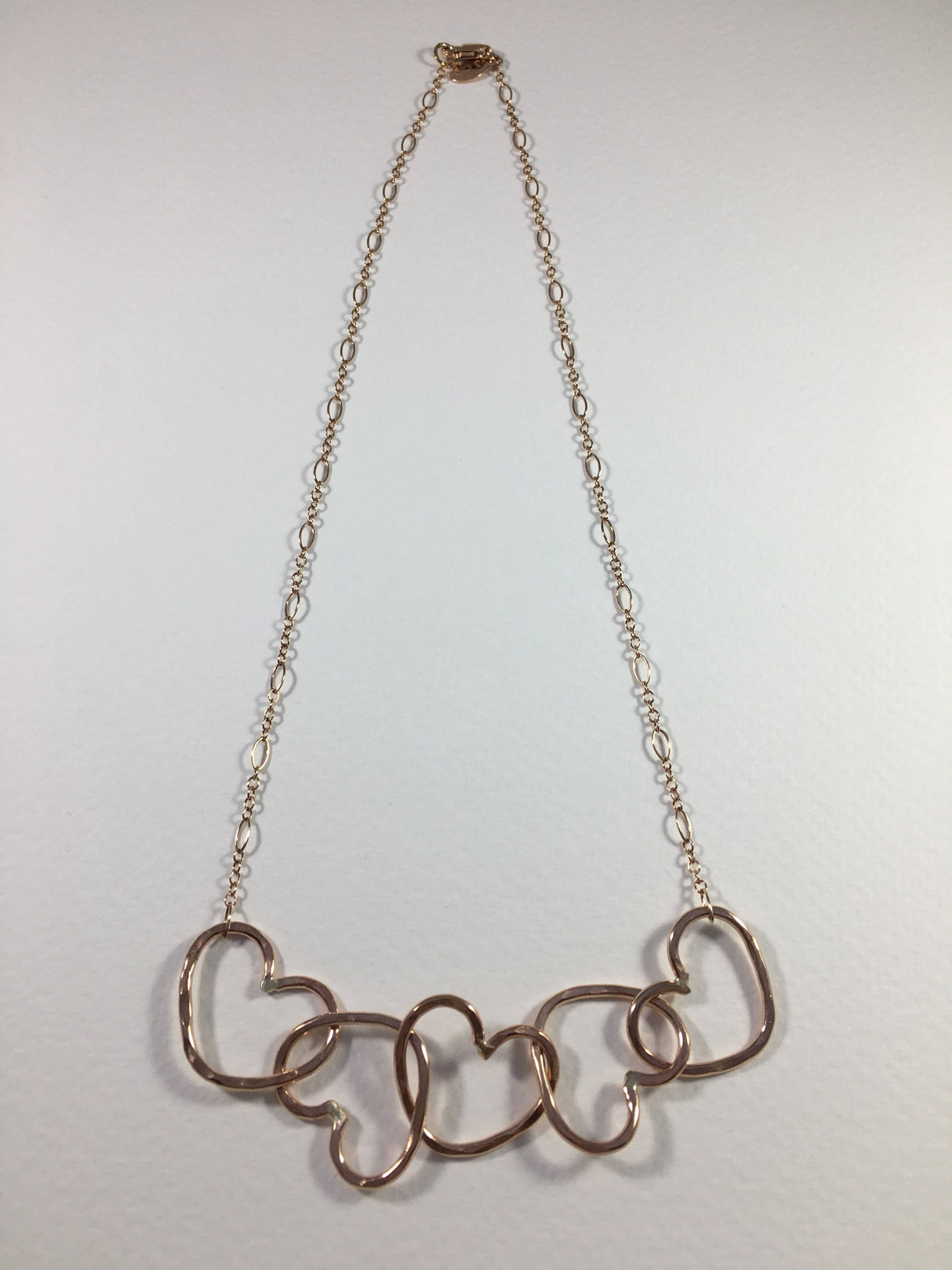 Five Hearts Linked Necklace by Jennifer Cervelli Jewelry